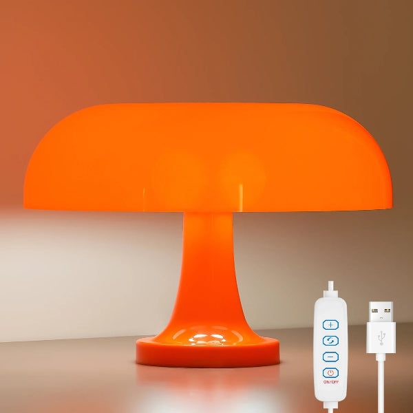 The Projection Rooms Modern Danish Mushroom Table Lamp is an orange LED bedside lamp with dimmable lighting, a USB power cord, and remote control for power, light modes, and brightness. The lamp emits a warm glow when lit.