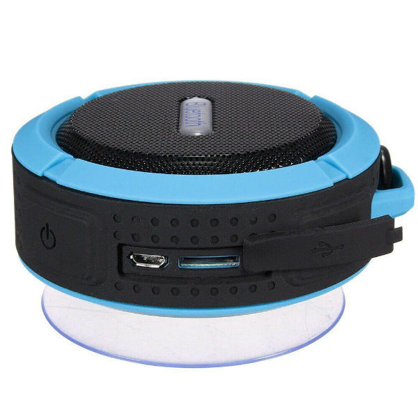 The Projection Rooms Portable Waterproof Wireless Mini Bluetooth Music Speaker is compact with a black mesh top, blue and black body, offering high-fidelity sound. It includes side power and charging ports covered by a rubber flap, and features a suction cup base underneath.