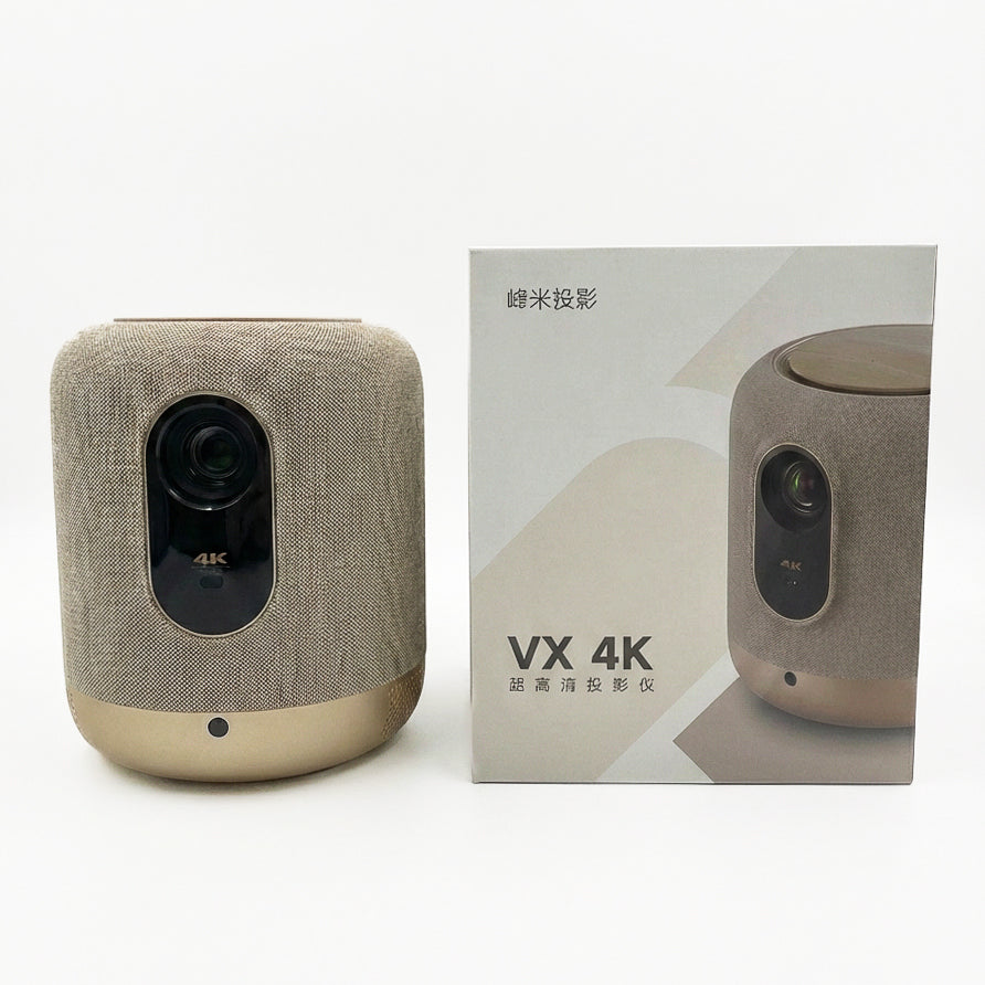 The FORMOVIE V10 Projector in beige and gold sits beside its box, which shows the projector and product info in English and Chinese. With 2500 ANSI lumens and 4K UHD, it delivers vibrant visuals for immersive viewing.