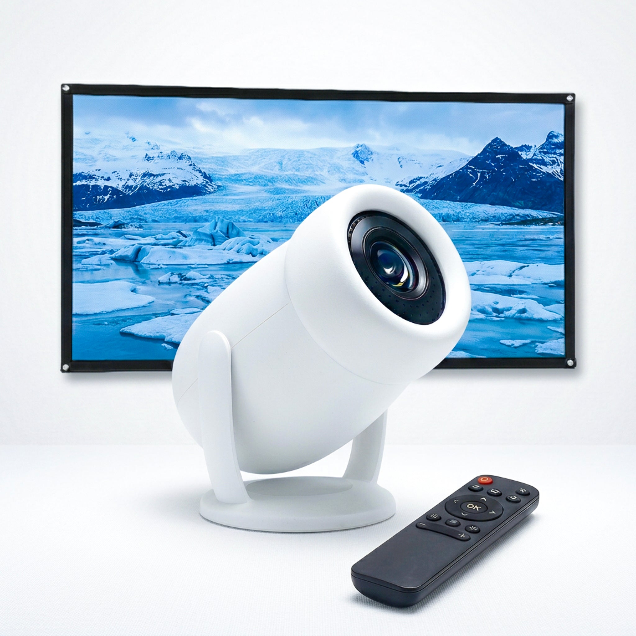 The Projection Room Neo Cloud Mini Projector in white with a black remote is positioned before a screen showing icebergs and snowy mountains over tranquil blue water.