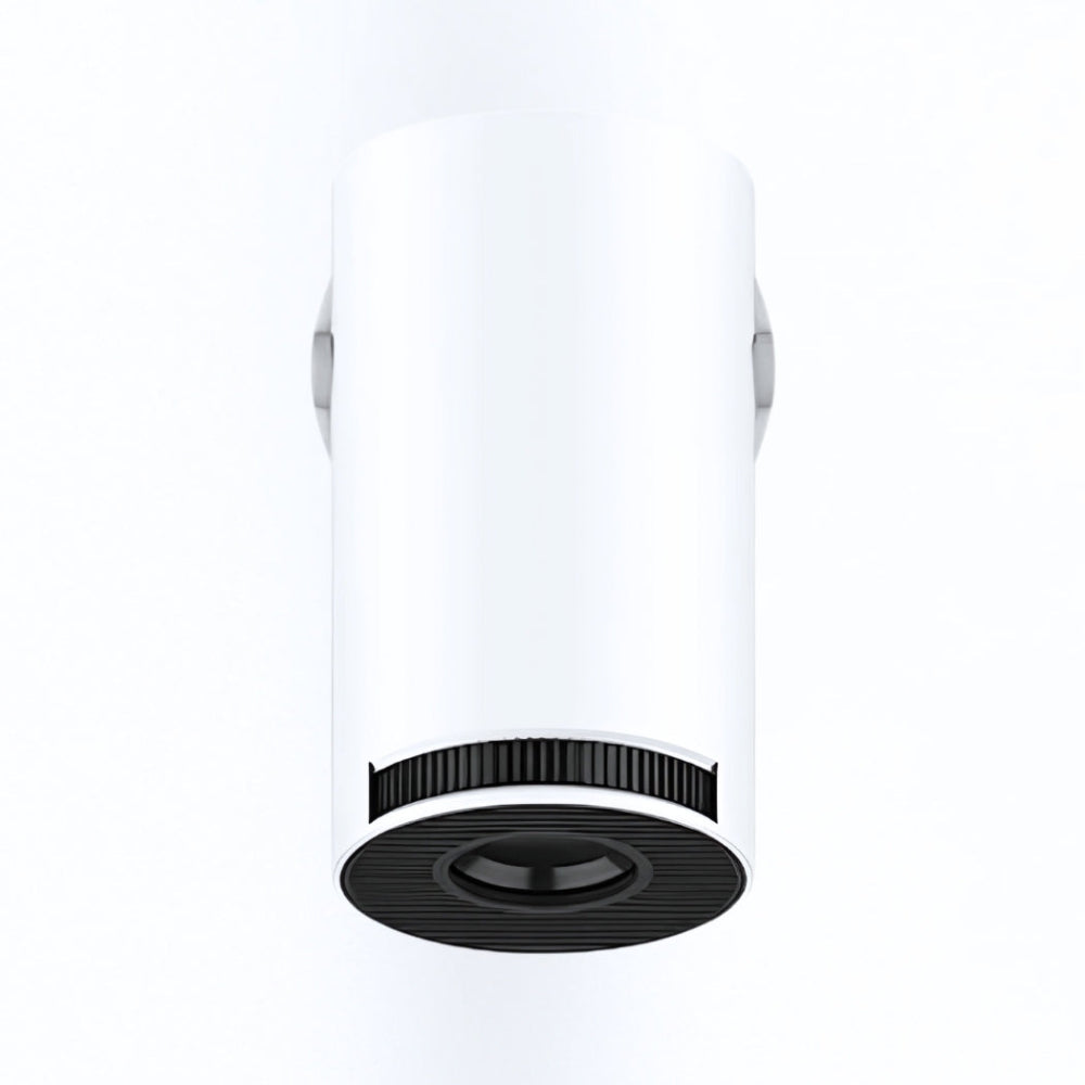 The Spotlight Projector by The Projection Room is a white, cylindrical, ceiling-mounted device with a black lens and vent details, ideal for spaces featuring HD projector setups or wireless streaming devices, shown on a plain white background.