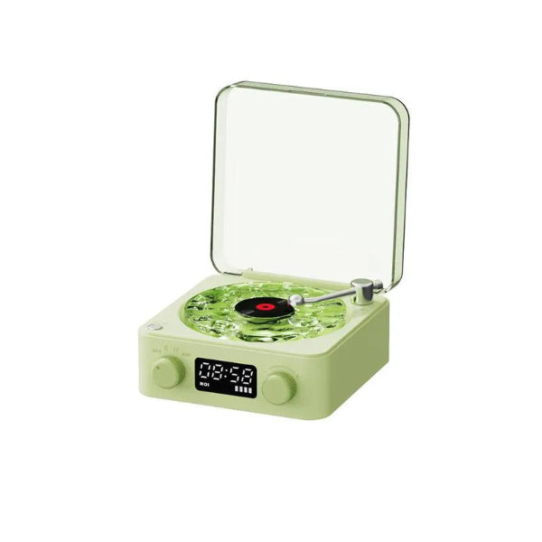 The Projection Rooms Vinyl Speaker Lamp, styled in retro green with an ocean wave design and transparent lid, features a small vinyl record on the platter. It includes a digital display, front control knobs for high-quality sound, and multifunctional connectivity with RGB lighting.