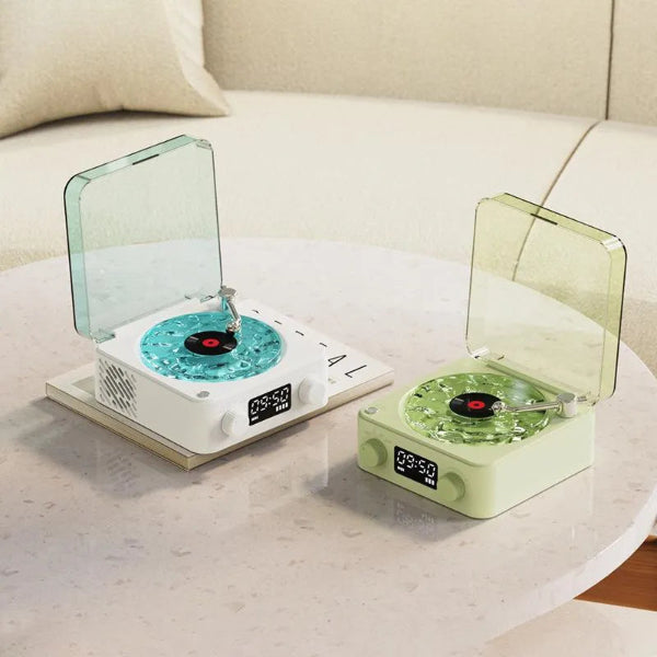 Two Vinyl Speaker Lamps from The Projection Room, with an Ocean Wave Design in white and blue, and pale green, display 10:59 on a marble table in front of a light-colored couch. They blend style with high-quality sound.