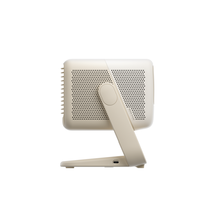 A side view of the beige JMGO N1S Nano by JMGO shows its perforated panel and adjustable stand, featuring Google TV and resembling a compact tabletop fan or air purifier.