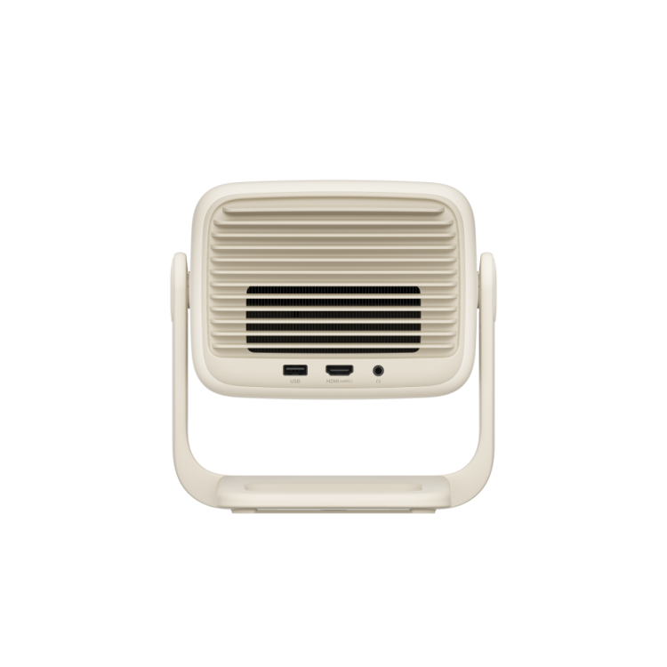 The JMGO N1S Nano by JMGO is a beige rectangular device with a vented front grill, USB and audio ports at the bottom, and a U-shaped stand—ideal for enjoying Dolby Audio on the big screen.