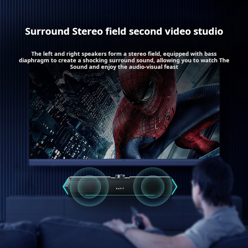 A man relaxes on a couch watching a Spiderman movie on a big TV. Text spotlights powerful surround stereo sound from The Projection Room’s RGB Bluetooth Speakers, with vibrant RGB lighting and 3.5MM audio jack, accented by blue sound wave graphics.