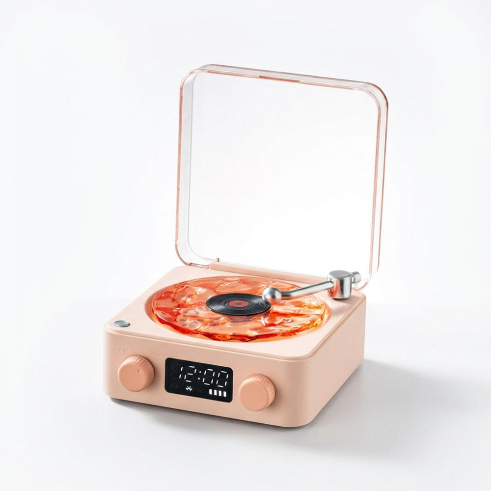 The Projection Room’s Vinyl Speaker Lamp is a modern beige turntable with a transparent lid, digital display, and two knobs. Featuring Bluetooth streaming, it displays an orange swirl vinyl on a plain white background.